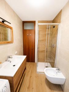 a bathroom with a sink and a shower at Appartamento Italia in Alleghe +12 photos