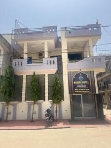 a building with a motorcycle parked in front of it at Basuki Hotel in Jaipur