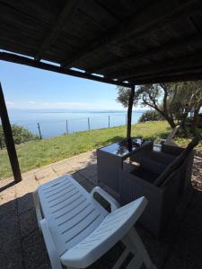 a patio with a chair and a couch and a table at Apartment Kalikut in Beli