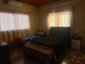 a bedroom with a bed and a window with curtains at Jean Pierre in La Merced