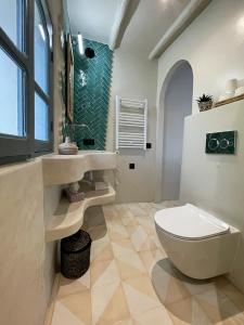 a bathroom with a toilet and a sink and a window at Dar Serenia Rohuna in Rehouna +25 photos