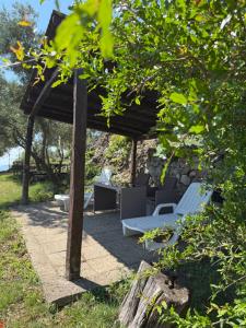 a wooden pergola with two beds and a table at Apartment Kalikut in Beli +18 photos