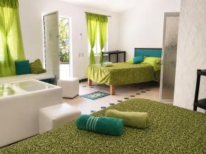 a bathroom with two beds and a bath tub at Casa ANTAHKARANA in Puerto Vallarta