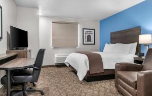 a hotel room with a bed and a desk at My Place Hotel-Jonesboro, AR in Jonesboro