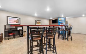 a bar with bar stools in a barber shop at My Place Hotel-Jonesboro, AR in Jonesboro