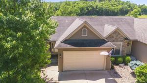 a house with a garage with a roof at TeeTime Green On the Fairway in Camdenton
