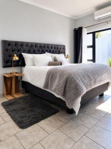 a bedroom with a large bed and a window at CAVE Properties Group in Pionierspark