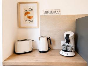 a counter with two coffeemakers and a coffee bar at La petite maison secrète in Abbeville +5 photos