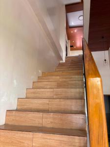 a staircase in a building with a wooden rail at Silid in Legazpi