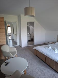 a bedroom with a bed and a table and a mirror at Casa Nițică in Vaslui