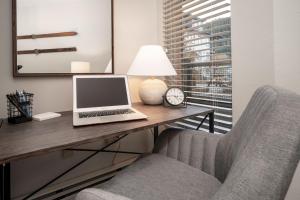 a desk with a laptop and a chair in a room at Fraser Crossing 3309 in Winter Park