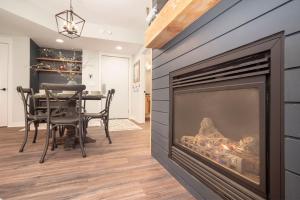 a fireplace in a dining room with a table and chairs at Fraser Crossing 3309 in Winter Park