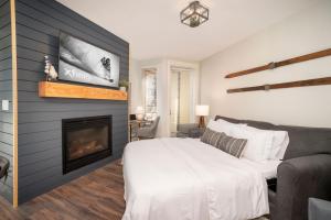 a bedroom with a bed and a fireplace at Fraser Crossing 3309 in Winter Park
