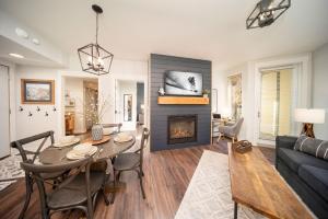 a living room with a table and a fireplace at Fraser Crossing 3309 in Winter Park +27 photos