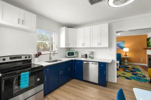 a kitchen with white cabinets and blue appliances at Everglades Villa - Sleeps 8 - Walk to Siesta Beach in Siesta Key