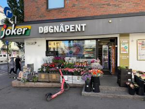 a scooter parked in front of a flower department store at Spacious Retreat in Oslo