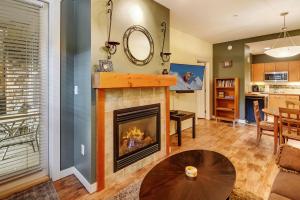 a living room with a fireplace and a table at Fraser Crossing 3127 in Winter Park