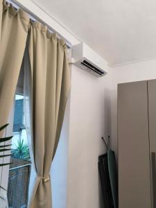 a curtain in a room with a window at Oasi urbana in Turin