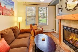 a living room with a couch and a fireplace at Fraser Crossing 3127 in Winter Park