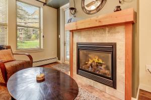 a living room with a fireplace and a table at Fraser Crossing 3127 in Winter Park
