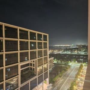 a view of a building at night with a city at 1556 Shore Residences tower C - MOA in Sampong