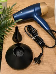 a blue blow dryer on top of a table at Anastasia's Luxury Suite with jacuzzi in Angairiá