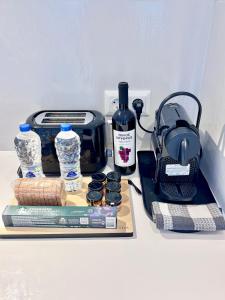 a table with a bottle of wine and a toaster at Anastasia's Luxury Suite with jacuzzi in Angairiá