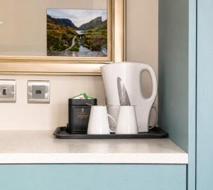 a shelf with a kitchen utensils on a counter at Pairc House Hotel in Birmingham