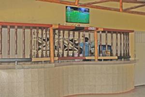 a check in counter at an airport with a tv at Kolstar Hotel SMC Ltd in Ogwam