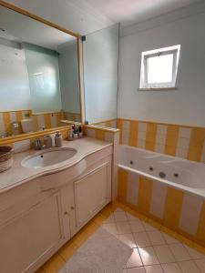 a bathroom with a sink and a tub and a mirror at The Throne in Alcabideche +19 photos