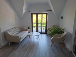 a living room with a couch and a table at Casa Nițică in Vaslui +1 photo