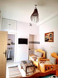 a living room with a couch and a table at Dar Aziz in Sousse