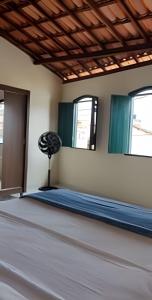 a room with a mattress on the floor and two windows at Casa do Renato Charmosa em Lençóis by LVF in Lençóis