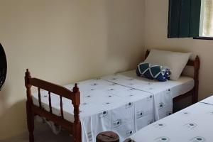 a small bedroom with a bed with a white mattress at Casa do Renato Charmosa em Lençóis by LVF in Lençóis