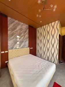 a bed in a room with a large window at Silid in Legazpi