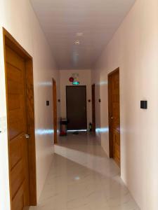 an empty hallway with two doors and a room at Silid in Legazpi