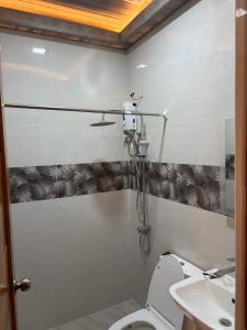 a bathroom with a toilet and a sink at Silid in Legazpi