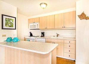 a kitchen with white cabinets and a counter top at Discovery Bay 1419 in Honolulu