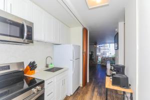 a kitchen with a sink and a refrigerator at Ilikai Marina 1285 in Honolulu