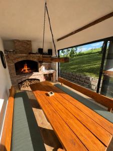 a living room with a wooden table and a fireplace at La casa de Nora in Duga Resa