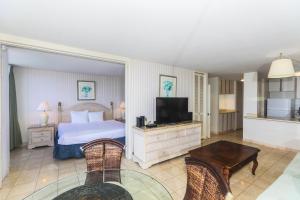 a bedroom with a bed and a television in it at Ilikai Marina 1584 in Honolulu