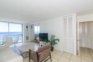 a living room with a couch and a table at Ilikai Marina 1688 in Honolulu