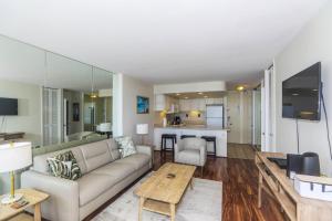 a living room with a couch and a table at Ilikai Marina 382 in Honolulu