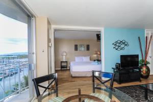 a bedroom with a bed and a view of a harbor at Ilikai Marina 984 in Honolulu