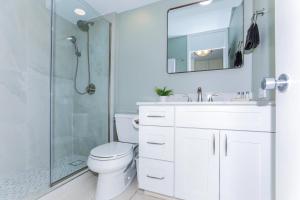 a bathroom with a white toilet and a shower at Ilikai Marina 987 in Honolulu +14 photos