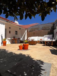 a patio with chairs and tables and a tent at Santa Maria do Castelo in Sesimbra