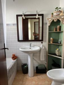 a bathroom with a sink and a mirror at Santa Maria do Castelo in Sesimbra +46 photos