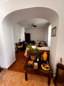 a living room with a table and a couch at Santa Maria do Castelo in Sesimbra