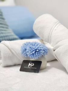 a blue flower sitting on top of a towel at 438 Shore Residences tower B - MOA in Sampong