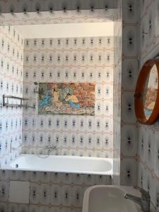 a bathroom with a sink and a tile wall at Complexe la brise tour 8 appt 815 in La Goulette